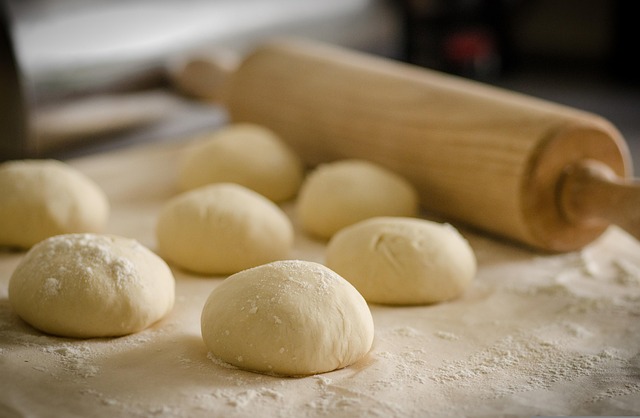 pastry dough rolling pin tart shells on marble surface with butter and flour