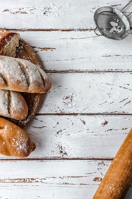 warm bakery interior with wooden countertops flour dusted work surface and natural light streaming through windows